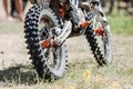 Close-up of muddy rear wheel and engine of dirt motorcycle