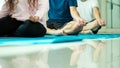 Close up mudra hand of threee Asian men and woman sitting in row practices yoga breathing meditation Royalty Free Stock Photo