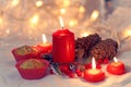 Close up of muffins in a red wrapper with red candles and holiday wreath. Bokeh background with a shallow depth of field. Royalty Free Stock Photo