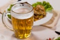 Close up Mug of Beer Beside Main Dish Royalty Free Stock Photo