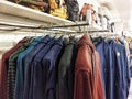 A close-up of a multi-colored hoodie jacket hanging neatly on a hanger in a retail clothing store Royalty Free Stock Photo