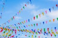 Multi colored party rainbow flags on blue sky for celebration Royalty Free Stock Photo