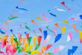Multi colored party rainbow flags on blue sky for celebration Royalty Free Stock Photo
