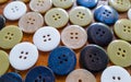Close up of multicolor buttons on wooden background