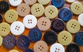 Close up of multicolor buttons on wooden background