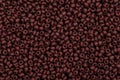 Multicolored brown seed beads background. Royalty Free Stock Photo