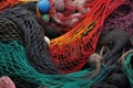 close-up of multicolored fishing nets stacked on a boat deck