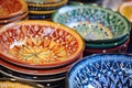 a close-up of a multicolored handmade ceramic dish at a market