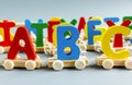 Close up Multicolored wooden letters with ABC on gray background. Set of toys for studying alphabet. Education, back to school Royalty Free Stock Photo