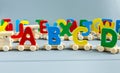 Close up Multicolored wooden letters with ABC on gray background. Set of toys for studying alphabet. Education, back to school Royalty Free Stock Photo