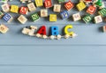 Close up Multicolored wooden letters with ABC on gray background. Set of toys for studying alphabet. Education, back to school Royalty Free Stock Photo