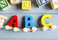 Close up Multicolored wooden letters with ABC on gray background. Set of toys for studying alphabet. Education, back to school Royalty Free Stock Photo