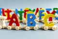 Close up Multicolored wooden letters with ABC on gray background. Set of toys for studying alphabet. Education, back to school Royalty Free Stock Photo