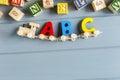 Close up Multicolored wooden letters with ABC on gray background. Set of toys for studying alphabet. Education, back to school Royalty Free Stock Photo