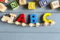 Close up Multicolored wooden letters with ABC on gray background. Set of toys for studying alphabet. Education, back to school Royalty Free Stock Photo