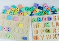 Close up Multicolored wooden letters with ABC on white wooden background. Set of toys for studying alphabet. Education, Royalty Free Stock Photo