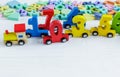 Close up Multicolored wooden numbers on white wooden background. Set of toys for studying mathematics. Education, back to school