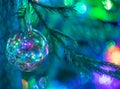 Close up multicolored xmas ball on Christmas tree with copy space and soft focus. Royalty Free Stock Photo