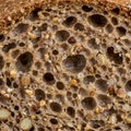 Close-up of a multigrain bread slice, showcasing a dense, porous texture with visible Royalty Free Stock Photo