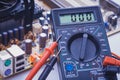 Close-up of multimeter on PCB plate Royalty Free Stock Photo
