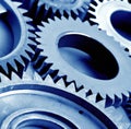 Close up of multiple blue cogs and gears on blue background