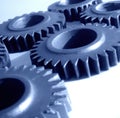 Close up of multiple blue cogs and gears on white background