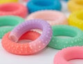 Close Up of Multiple Pastel Colored Finger Exerciser Rings on White Surface Royalty Free Stock Photo