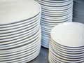 Close up of multiple stacks of white plates