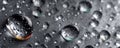 Water droplets on a dark surface with reflections and highlights for abstract macro texture Royalty Free Stock Photo