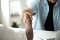 Close up of multiracial handshake over office desk Royalty Free Stock Photo