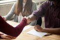 Close up of multiracial handshaking at job interview