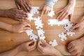 Close up multiracial people, team assembling puzzle, success teamwork Royalty Free Stock Photo