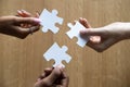 Close up of diverse people assemble jigsaw finding best solution Royalty Free Stock Photo