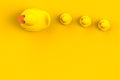 Close up of mum and baby rubber ducks isolated. Bath toys on a yellow background. Top view with copy space. Summer wallpaper. Royalty Free Stock Photo