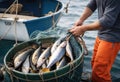 Close up of muscle hands of fisherman-sailor holds nets with fish catch. Hard sea work. Commercial Fishing Industry. Ai