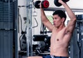 Close up of Muscular bodybuilder guy doing exercises with dumbbells.Young male fitness model lifting weights ,shirtless powerful Royalty Free Stock Photo