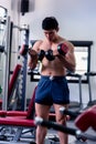Close up of Muscular bodybuilder guy doing exercises with dumbbells.Young male fitness model lifting weights ,shirtless powerful Royalty Free Stock Photo