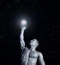 Close up of muscular bodybuilder guy doing exercises with weights over black background. Royalty Free Stock Photo