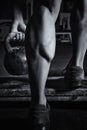 Close up of muscular bodybuilders leg doing exercises with weights