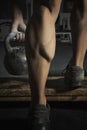 Close up of muscular bodybuilders leg doing exercises with weights