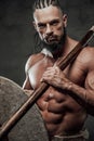 Close up of muscular viking with axe and shield in studio Royalty Free Stock Photo