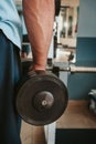 Close-up of a muscular young man lifting weights in gym Royalty Free Stock Photo
