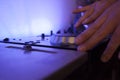 Close up of a music dj mixing tracks on his electronic console Royalty Free Stock Photo