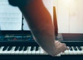 Close-up of a music performer`s man hand playing the piano from back Royalty Free Stock Photo