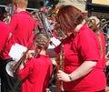 A close up of a musician from a brass band performing at the public brass march contest in hebden bridge town center