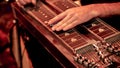 Musician playing lap steel, pedal guitar, slide guitar on stage.