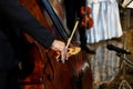 Close up musician`s hand is playing double bass in indoor event Royalty Free Stock Photo