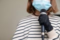 Close up of musician wearing medical face mask and holding microphone. Concept of performance and festival being canceled due to