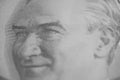 Close-up of Mustafa Kemal Ataturk\'s smiling face on a banknote.