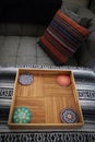 A close-up of of my orange throw pillow and coasters in a trays